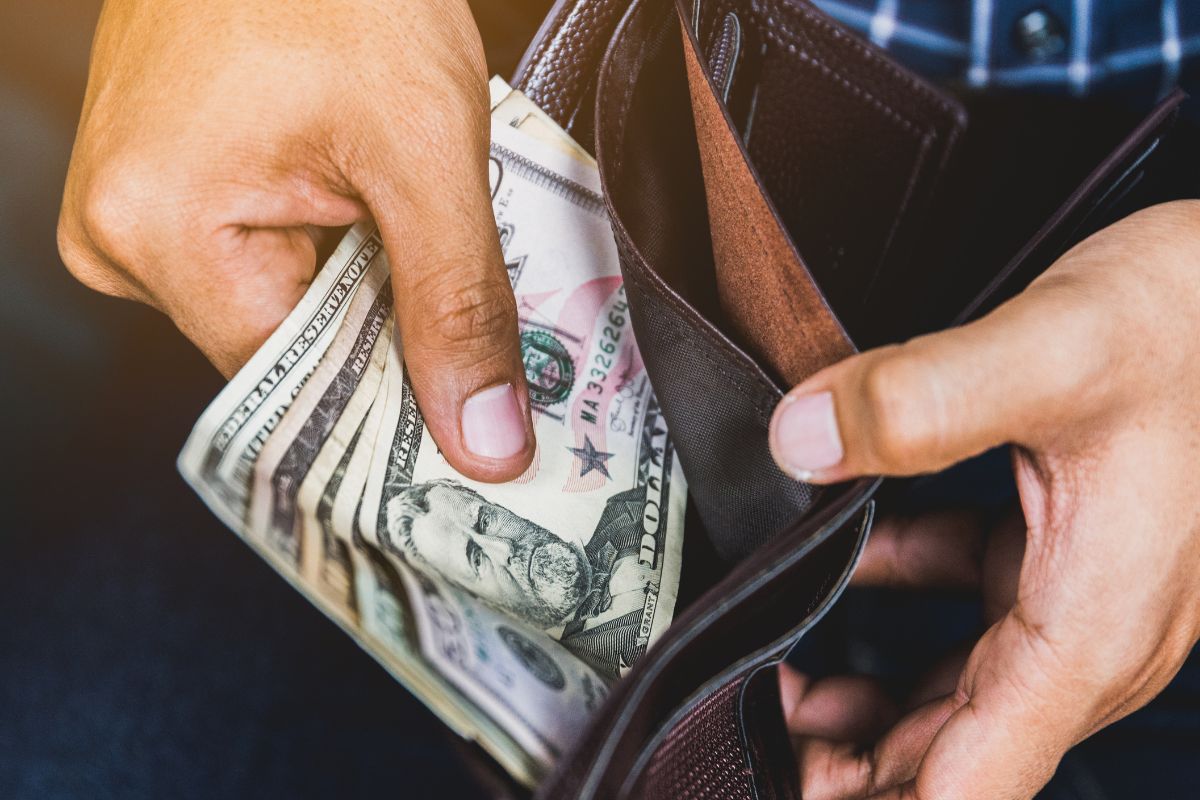 The photo shows a man not spending his money.