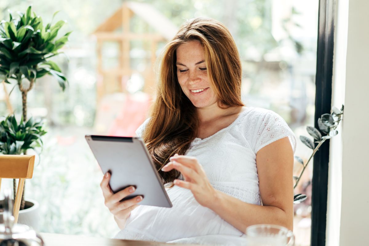 Picture of a woman using a tablet device.