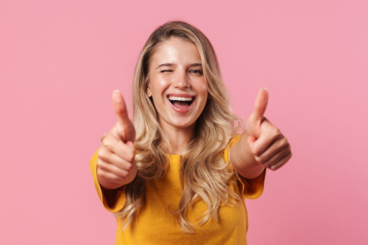 Photo of a woman doing an ok sign.