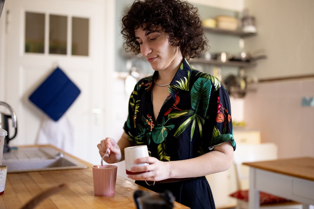 Photo of a person making a coffee.