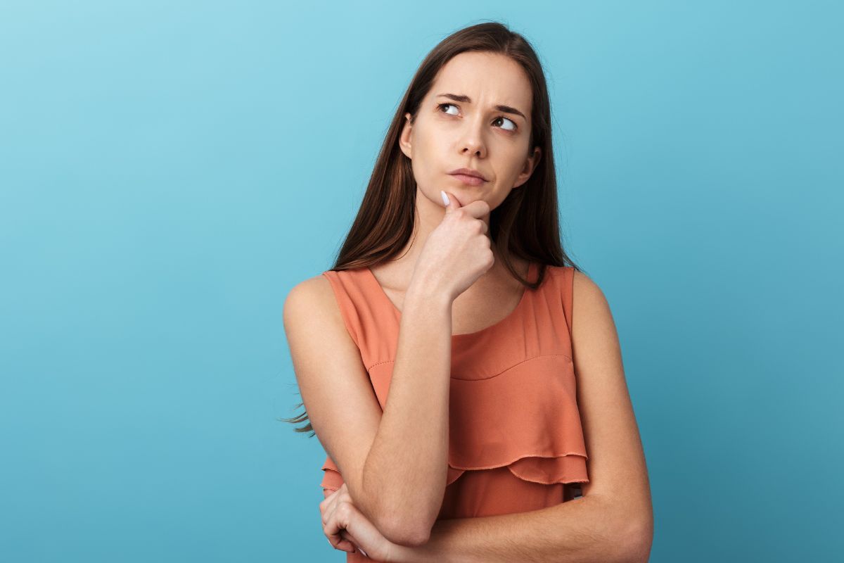 The image shows a woman thinking.
