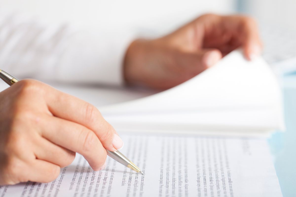 A man's hand reviewing his insurance.