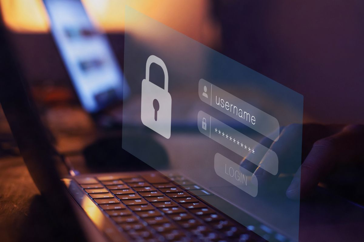 The photo shows a man's hand using a password manager.