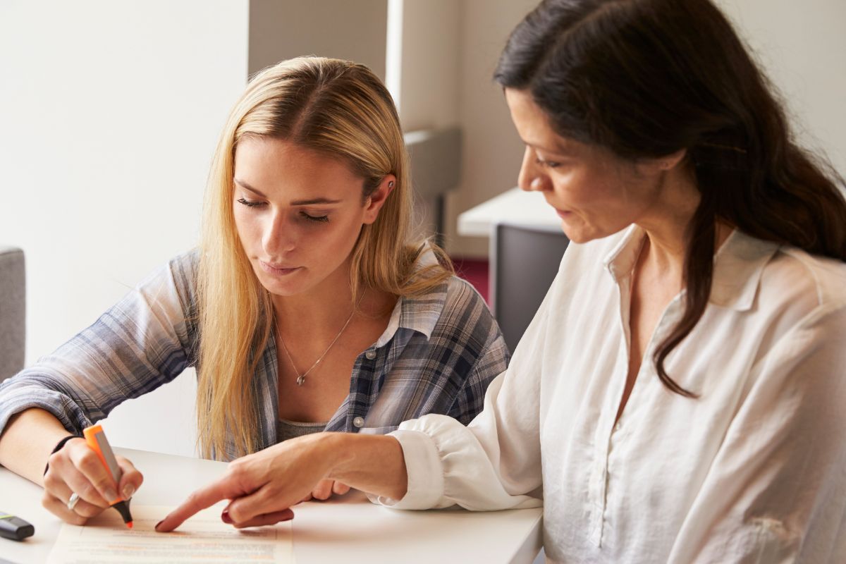 Image of a teacher tutoring a young woman.