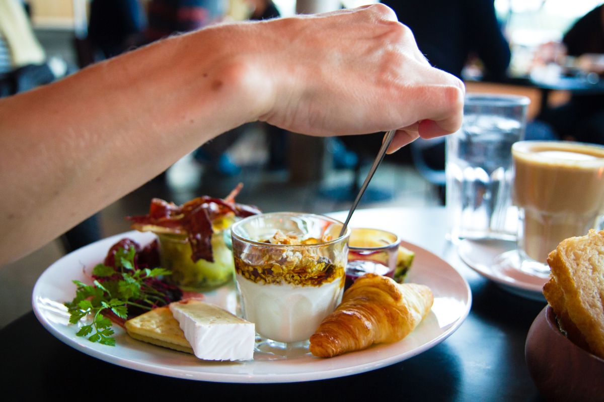 The image shows a man eating at the restaurant.