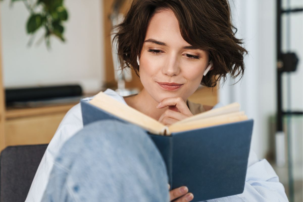 Image of a woman reading a book.