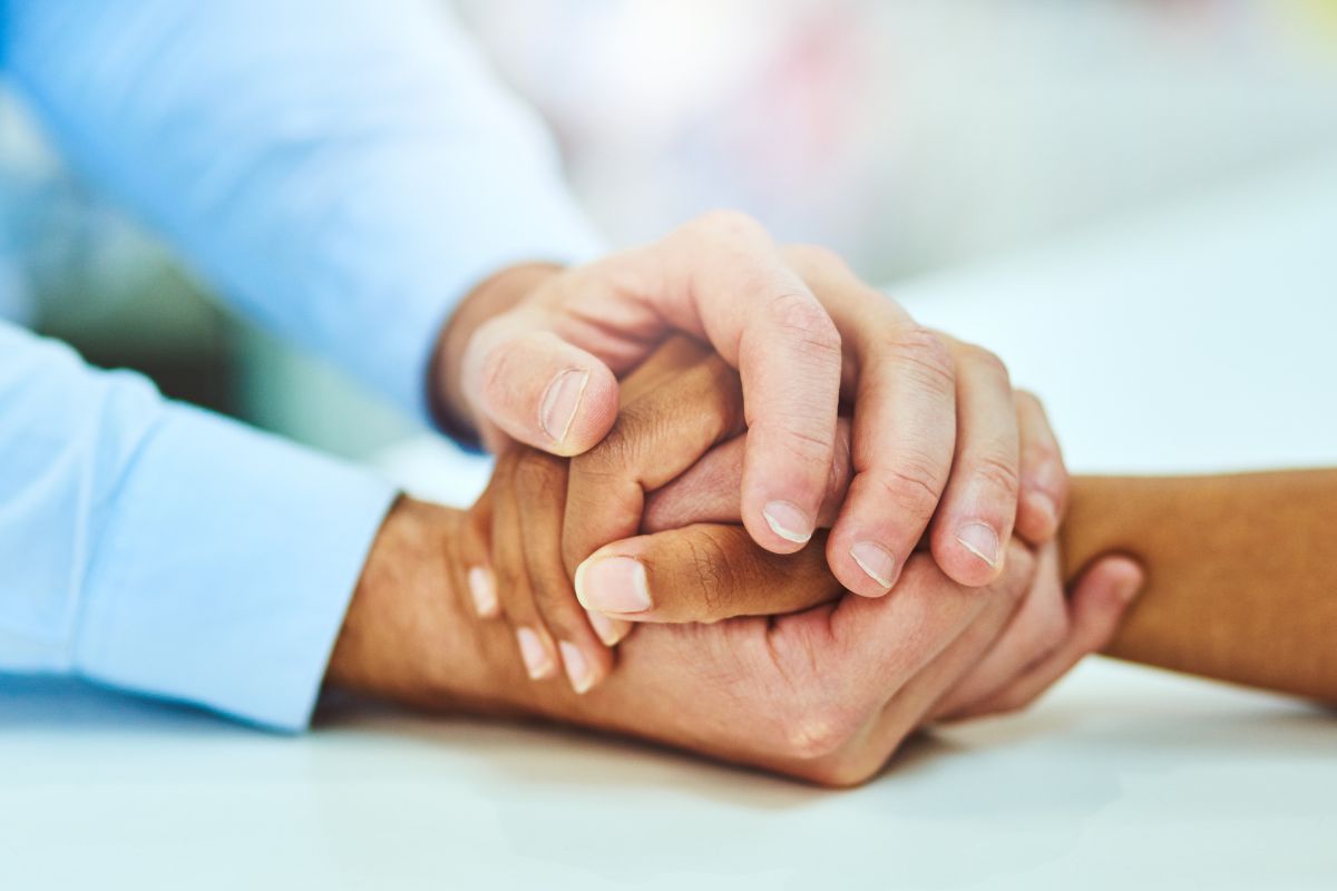 The photo shows them holding hands showing support.