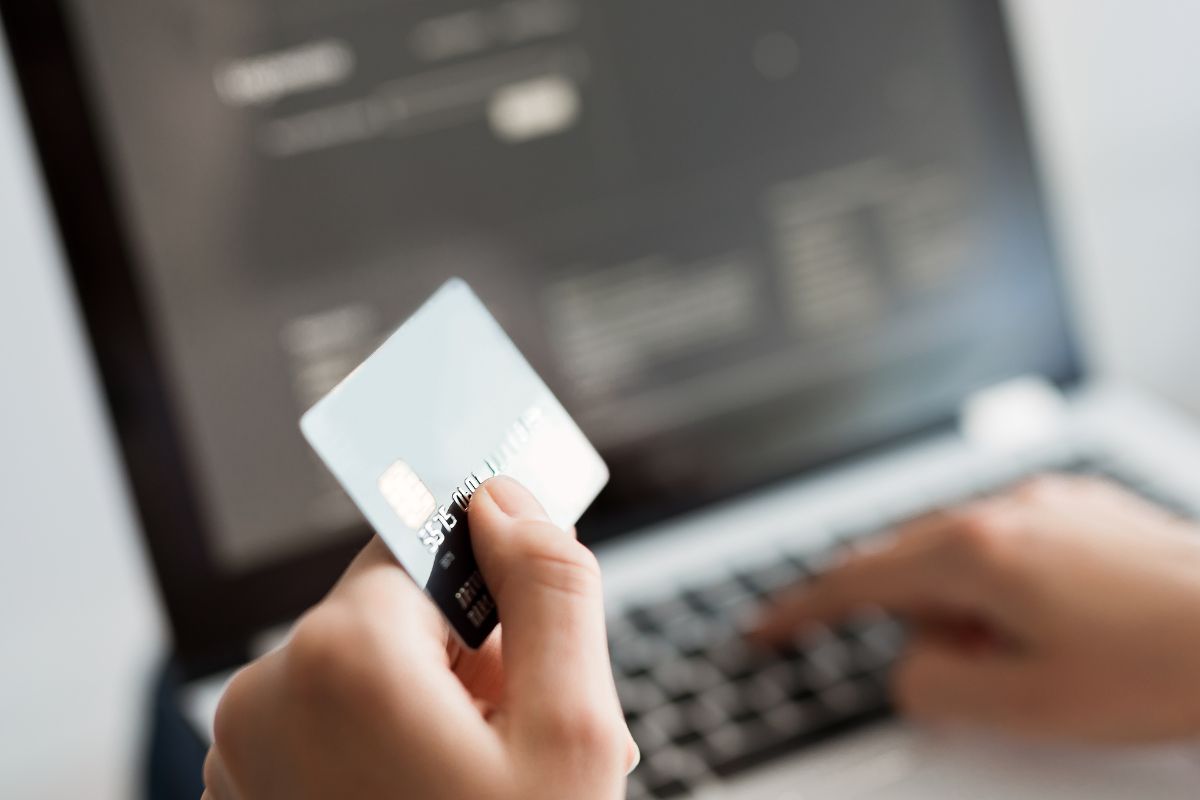 The image shows a man's hand transferring credit card points.