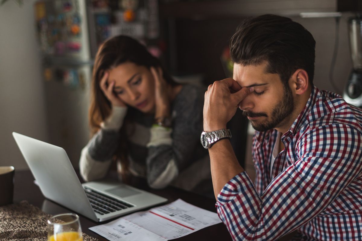 Picture of a couple worried about their debt.