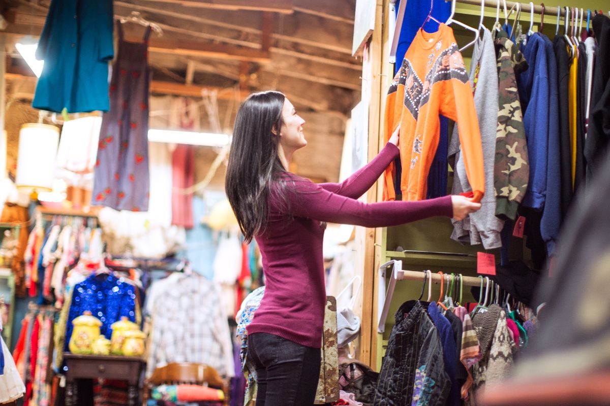 A picture of a woman shopping at the thrift store.