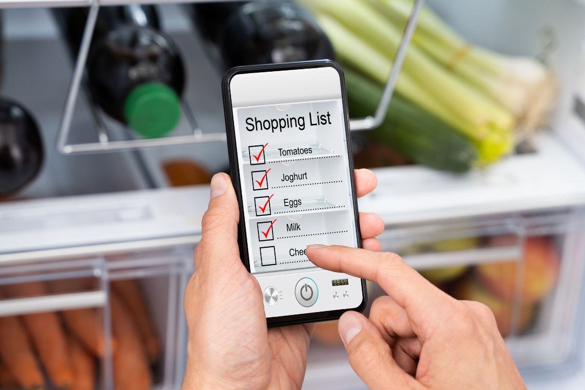 Image of a man's hand checking the shopping list.