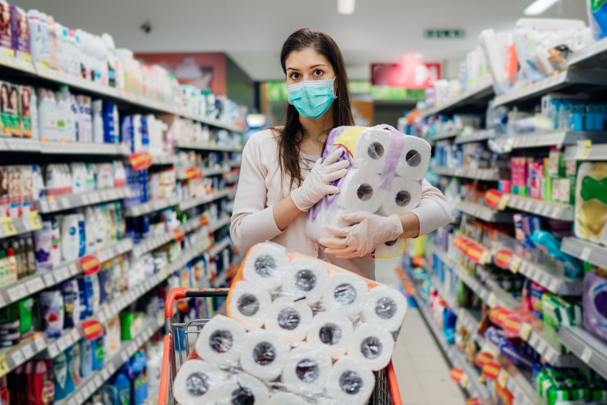 Photo of a woman buying bulk of toilet papers.