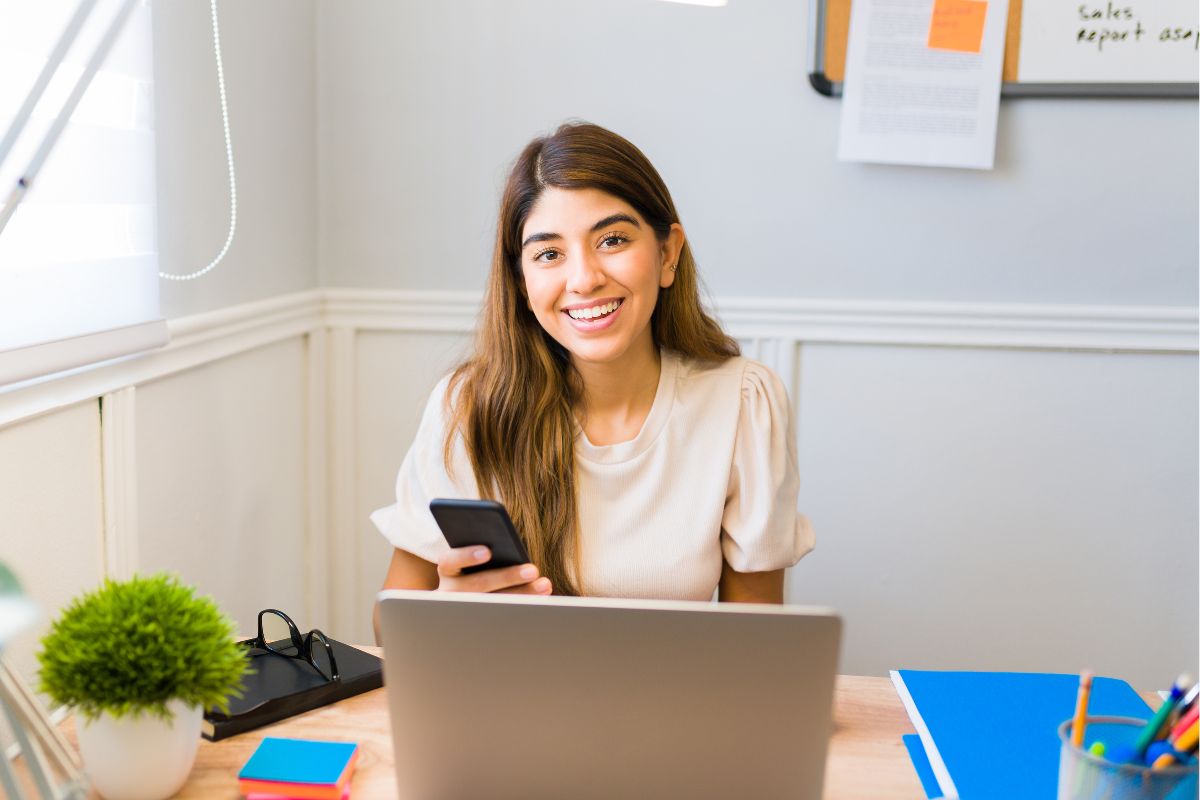 The photo shows a young woman working from home.