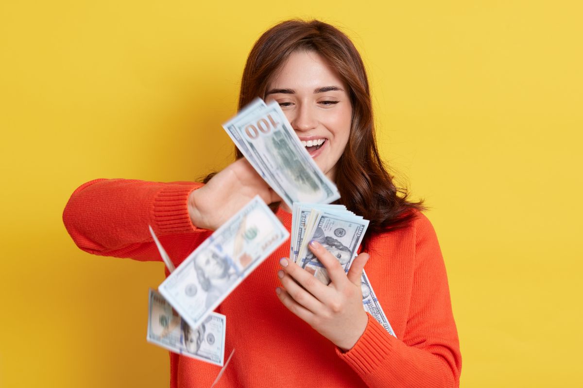 A young lady throwing money.