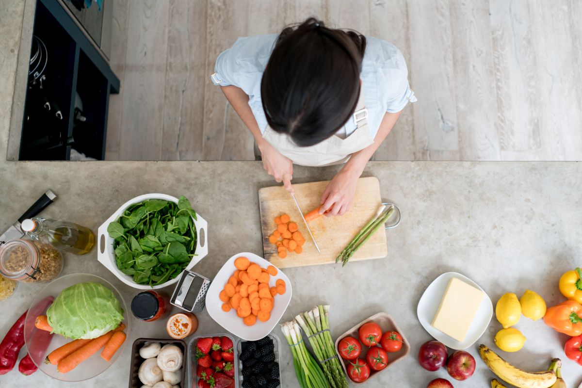 Photo of a woman slicing ingredients.