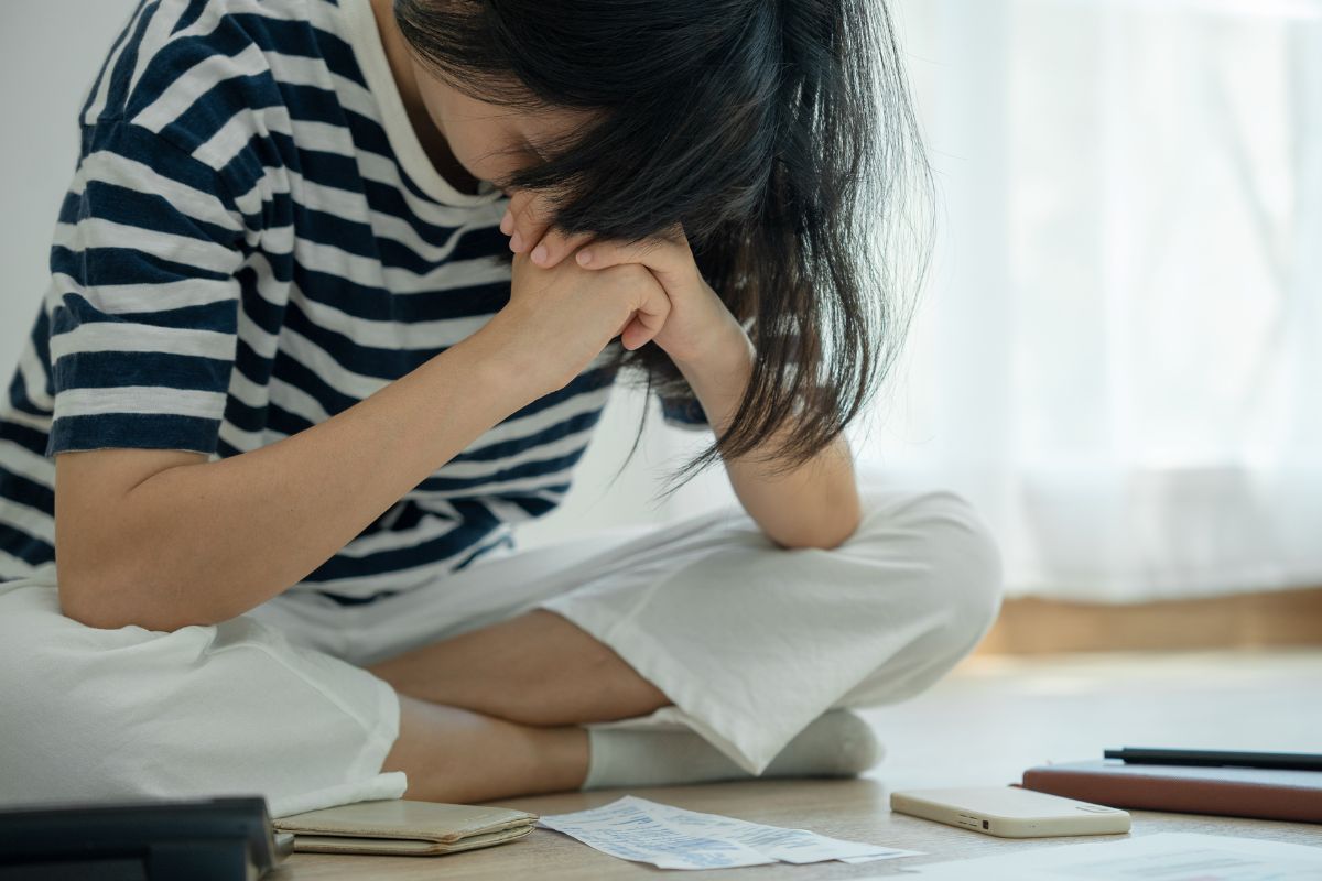 Picture of a frustrated woman with debt.