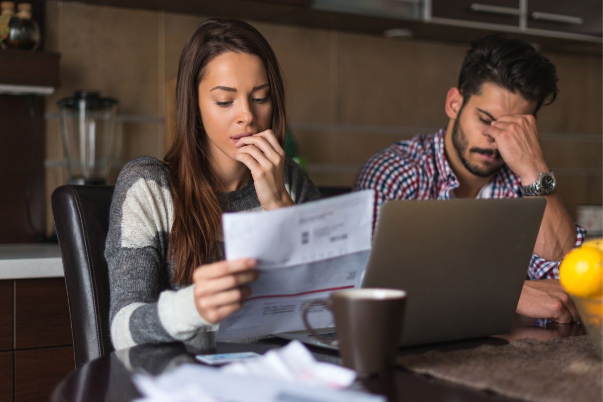 Picture of a couple worrying about debt.