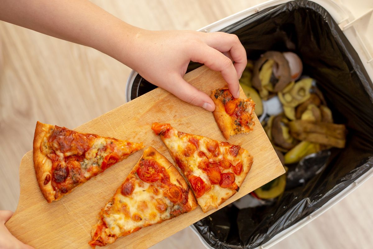 Photo of a woman's hand throwing food.