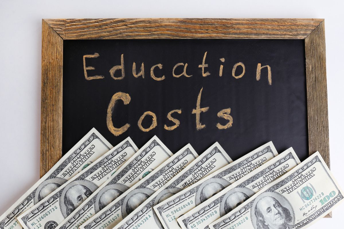 Image of money and board with education cost wording.