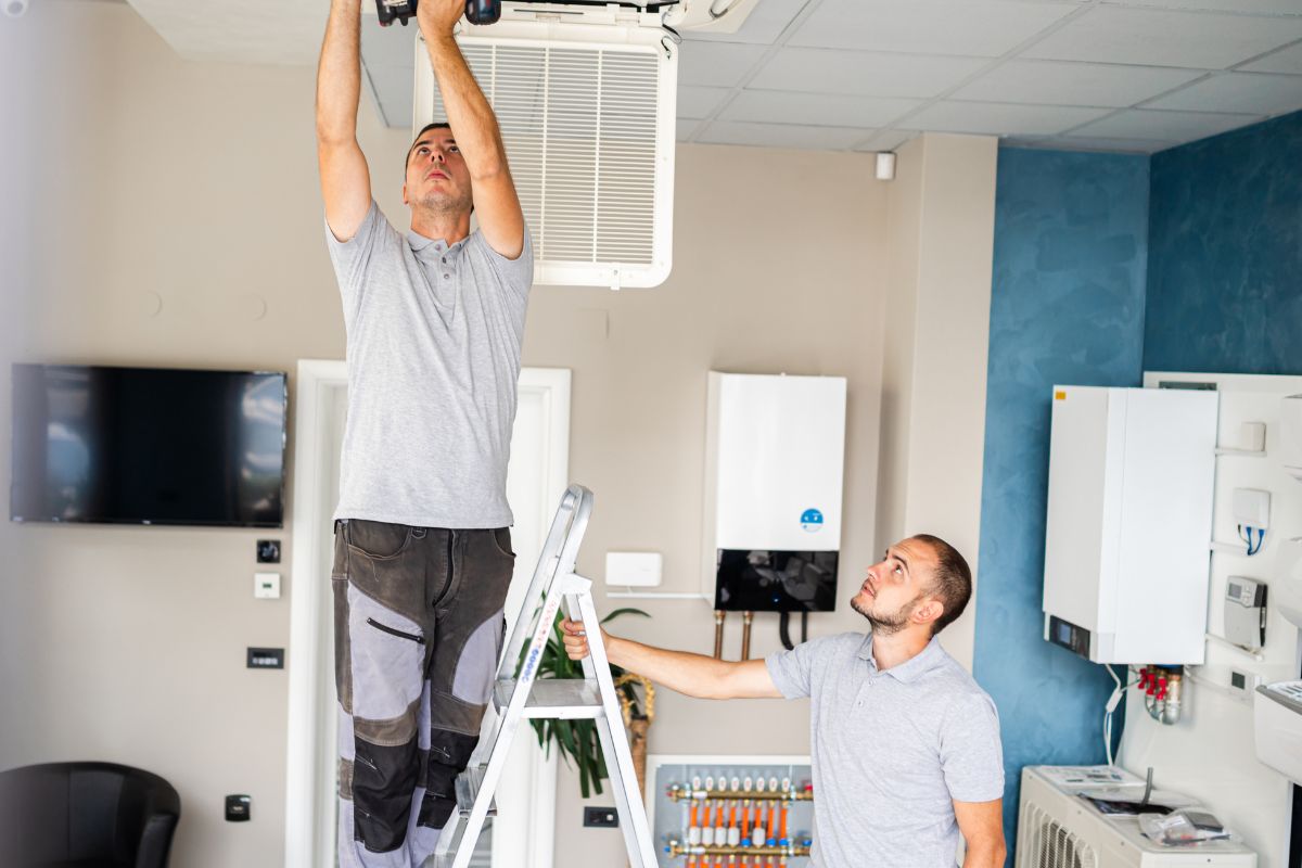 Picture of men repairing the ceiling.