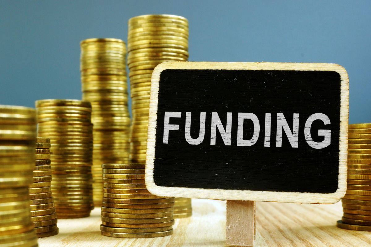 Picture of coins and funding wording.