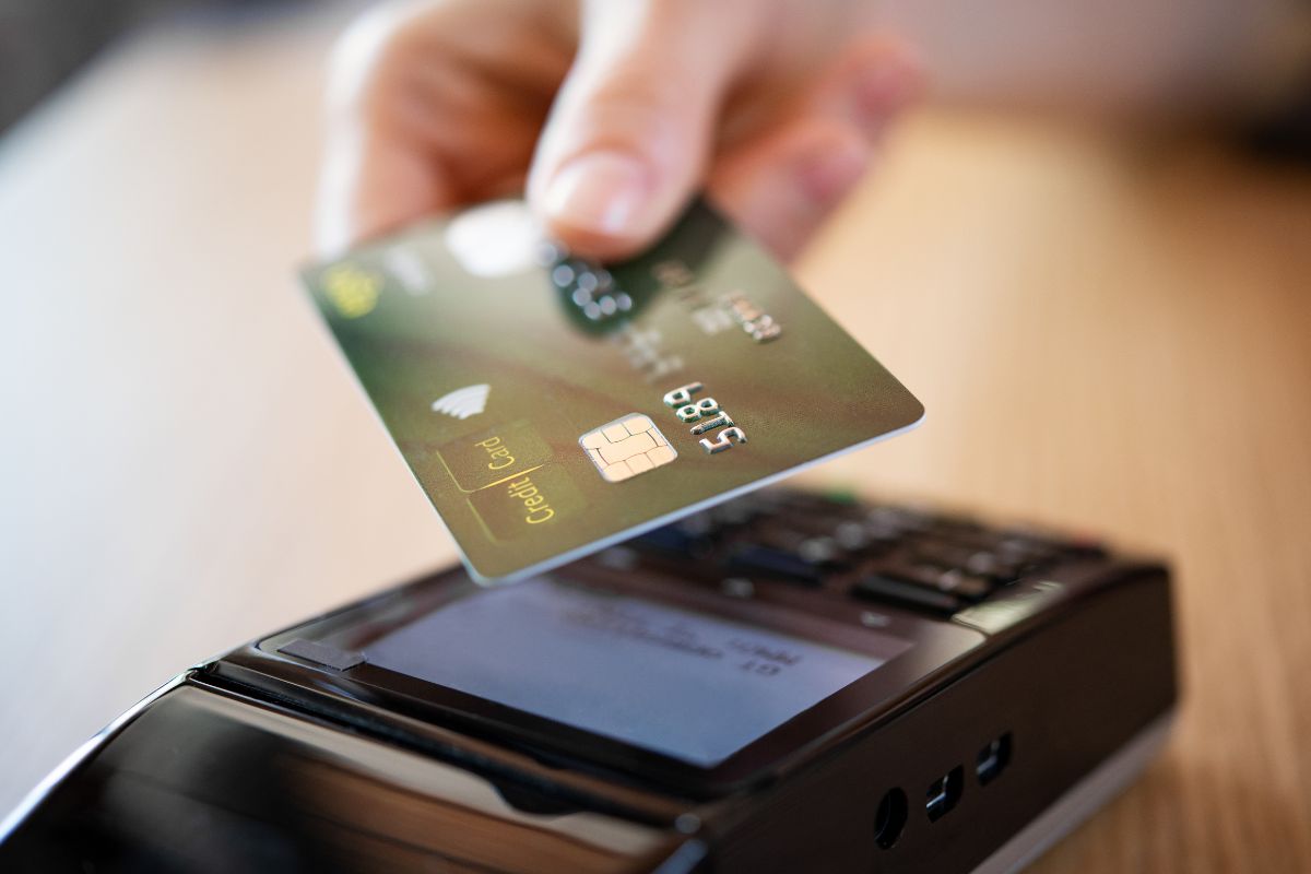 A woman's hand using a credit card.