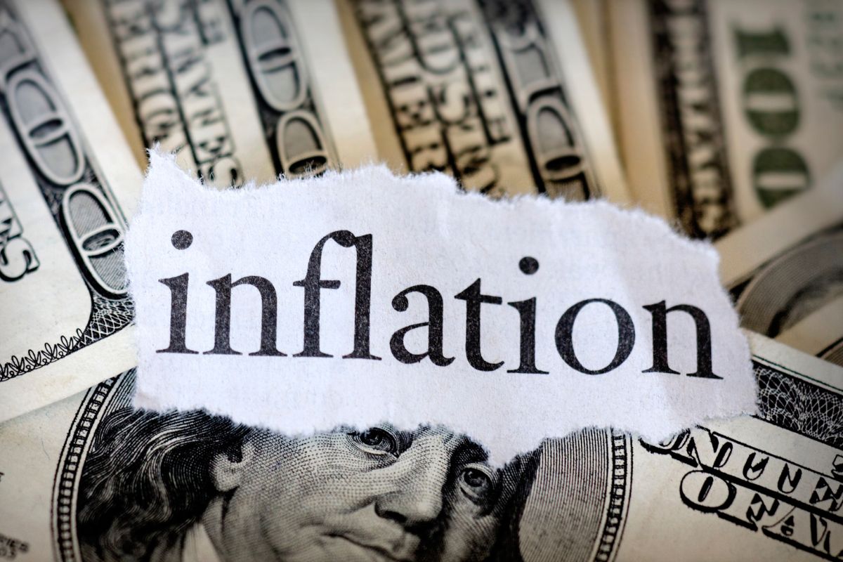 Photo of money and inflation wording.