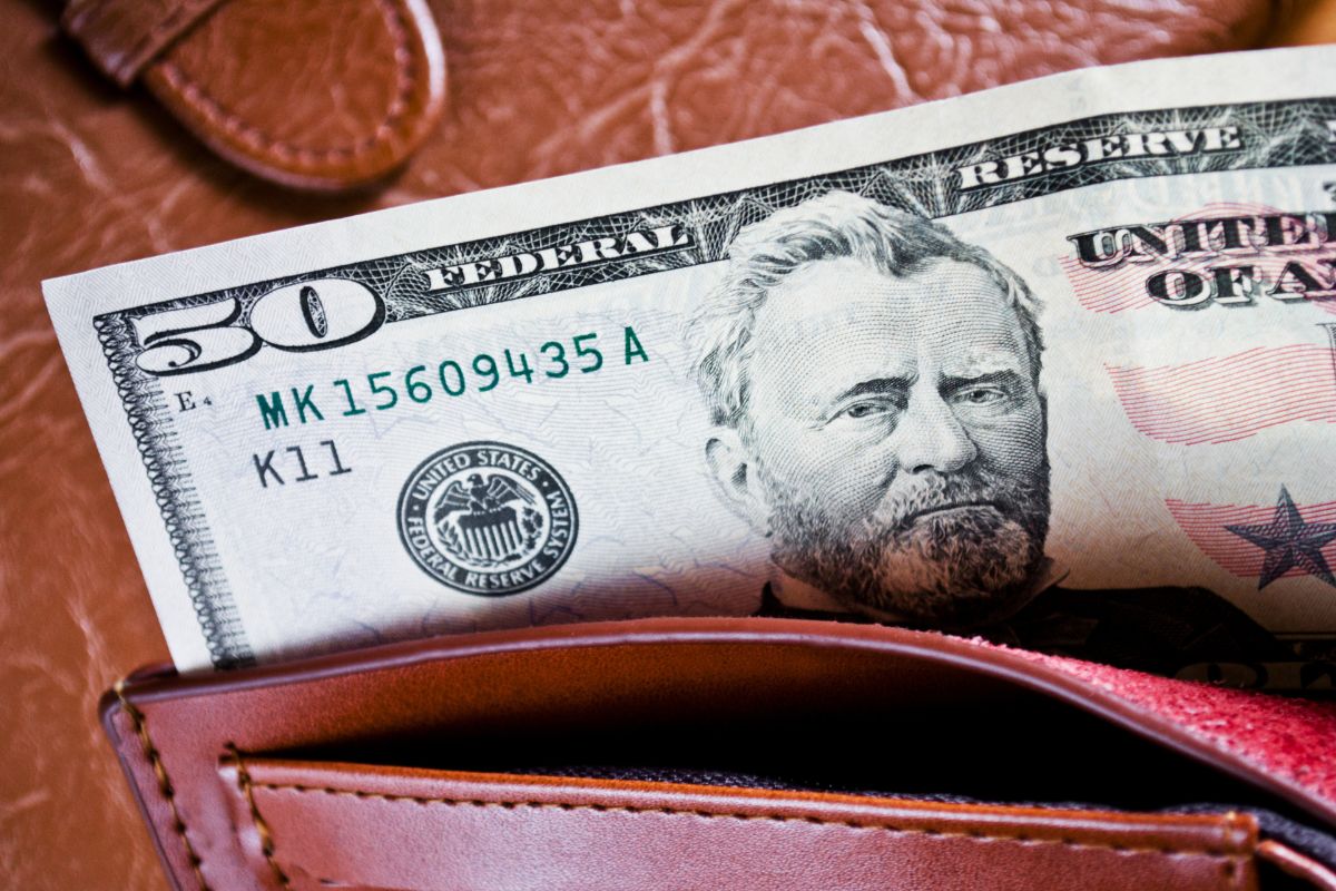 Photo of a wallet with money.