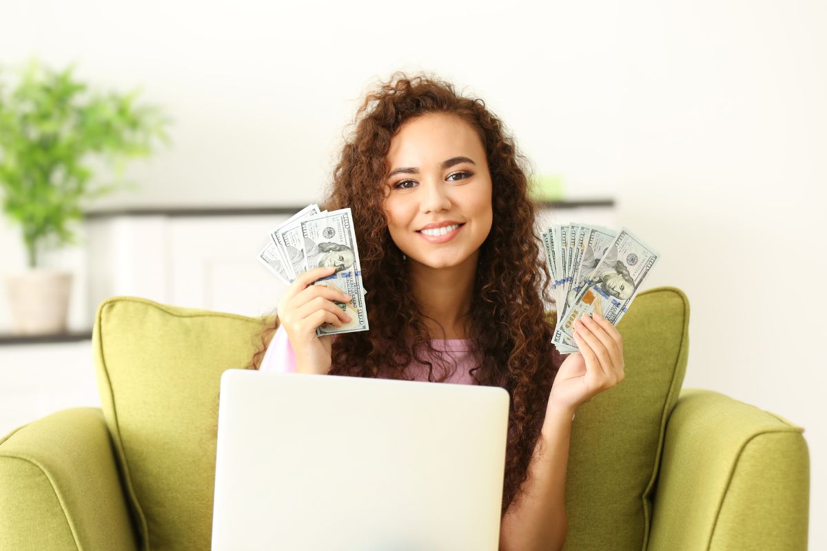 Photo of a woman holding money.