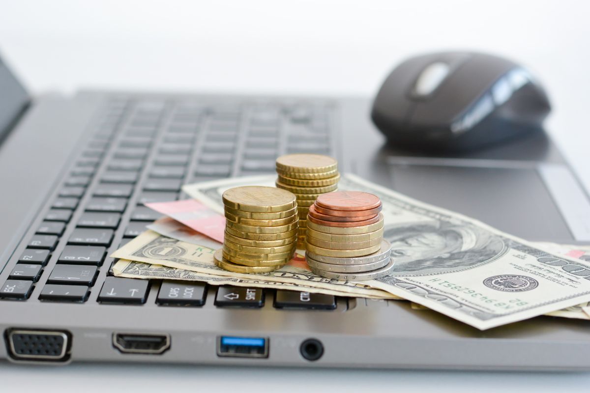 Image of a laptop and money.