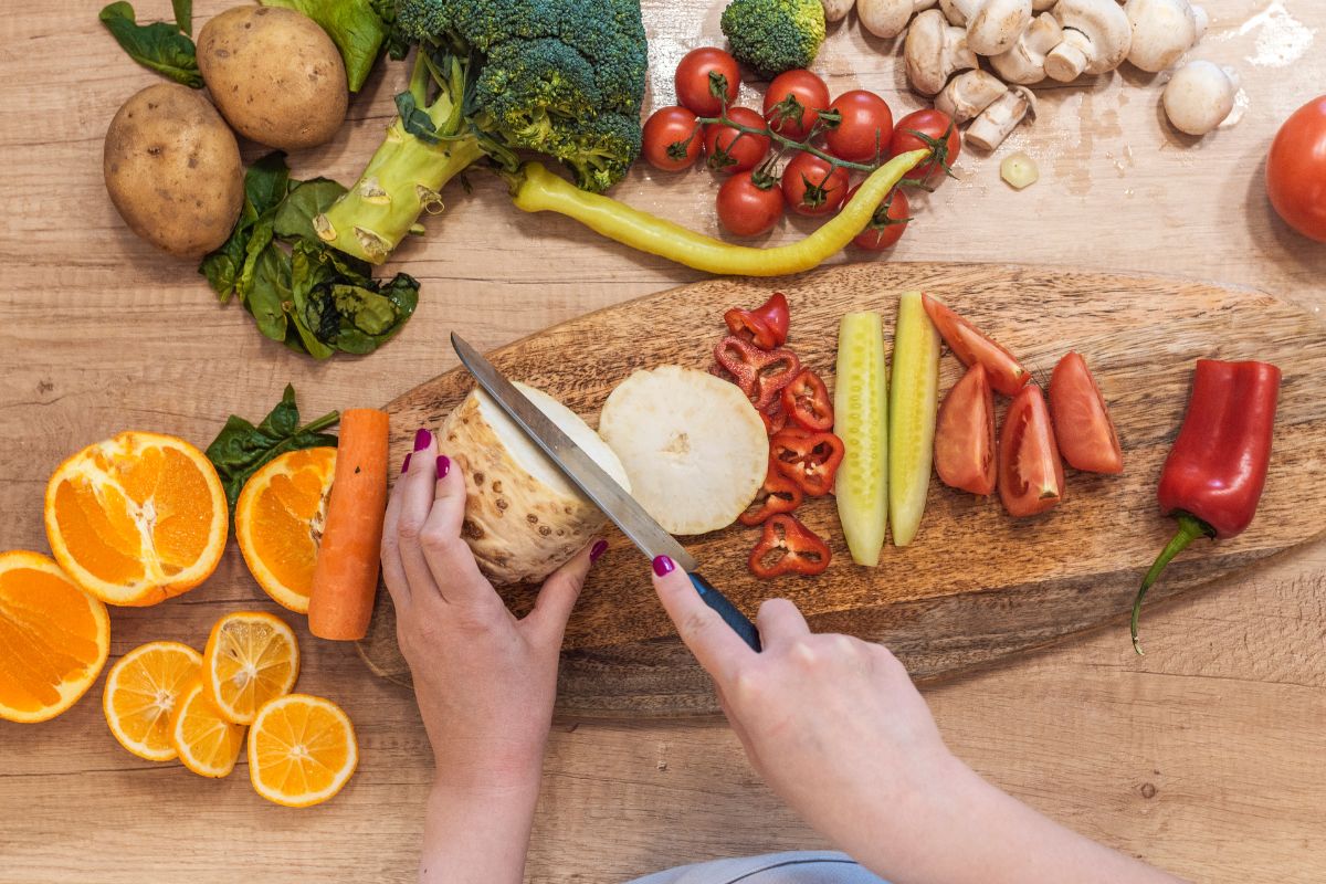 Photo of a woman's hand chopping ingredients.