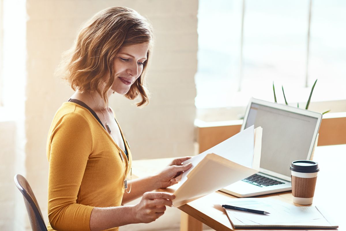 The image shows a woman proofreading.