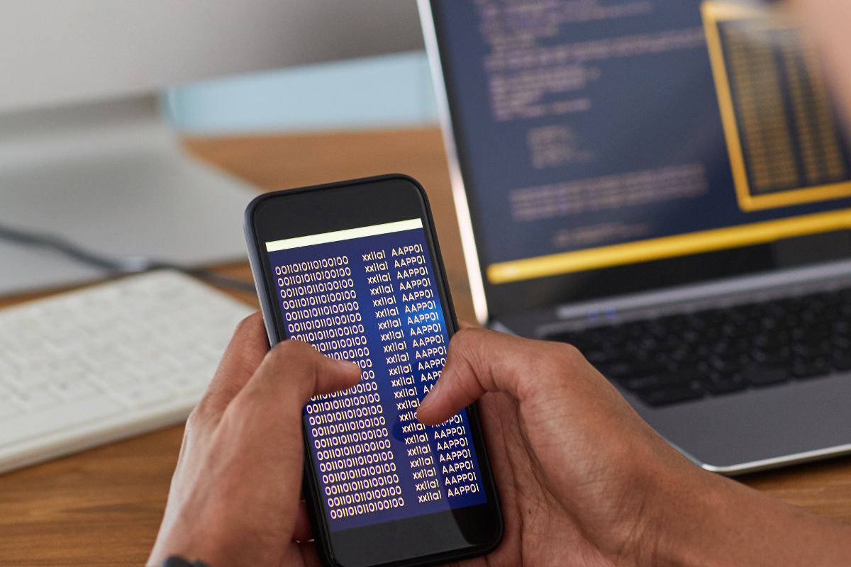 Picture of a man's hand coding.