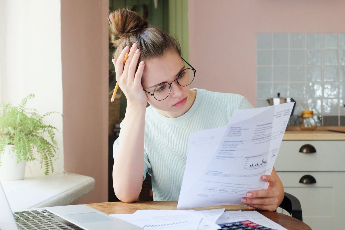 Picture of a woman reviewing her debt.