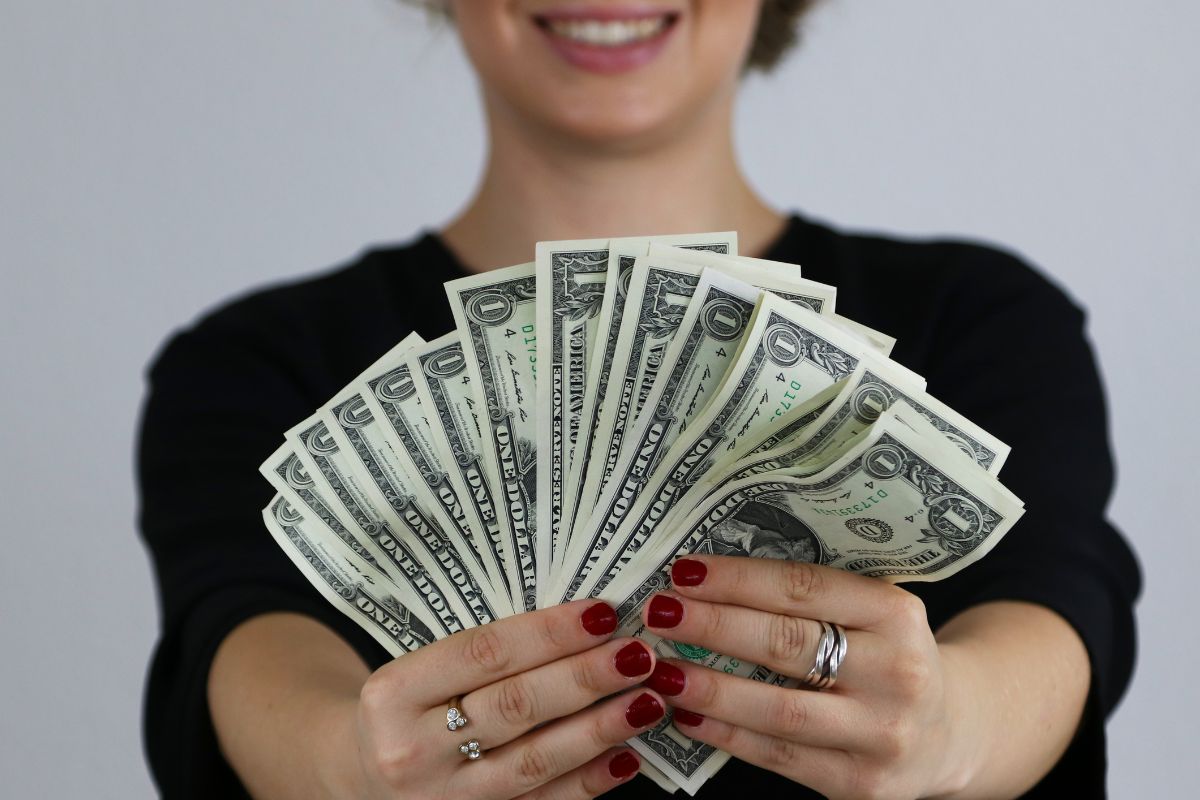 Image of a woman's hand holding money.