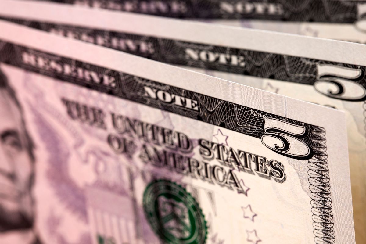 Photo of five dollar bills.