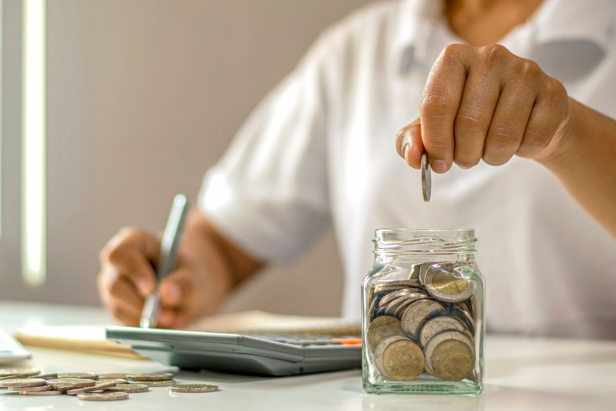 Picture of a woman's hand saving money.