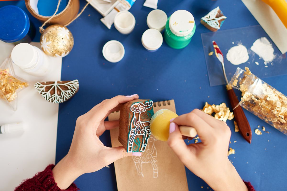 A woman's hand making and selling crafts.