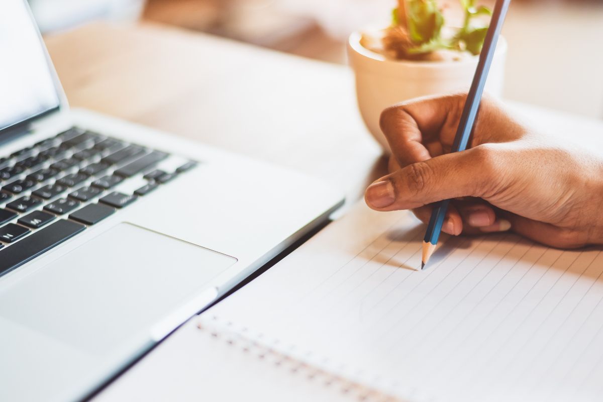 Photo of a woman's hand transcribing.