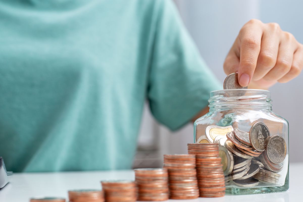 A woman's hand setting savings goals.