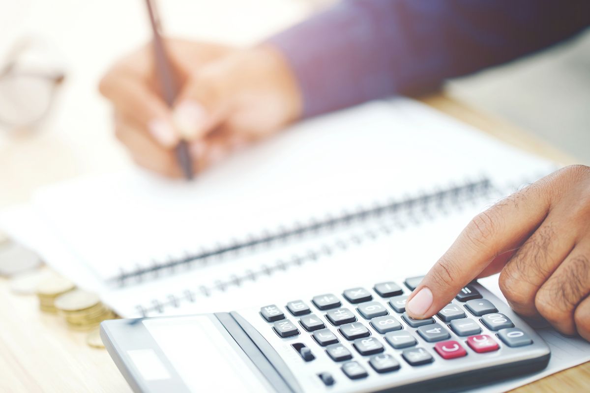 A man's hand budgeting.