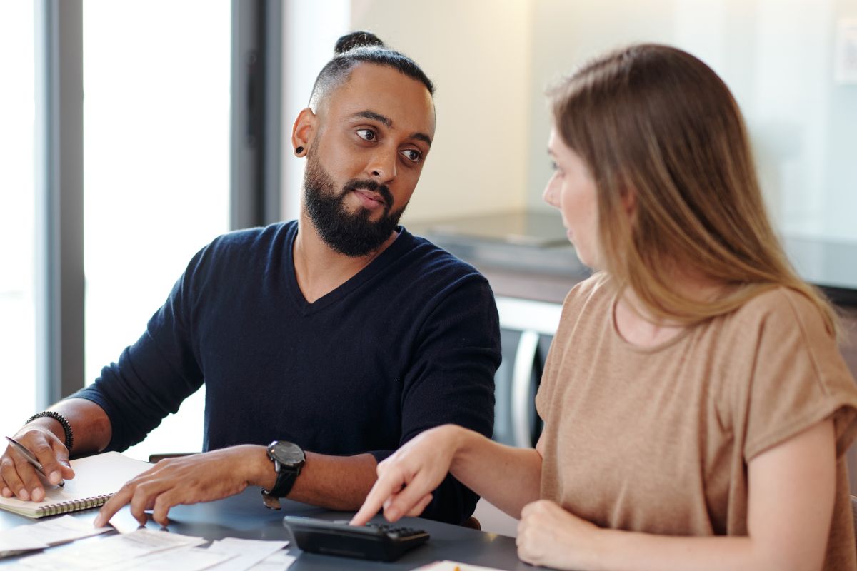 Image of a couple reviewing their weekly budget.