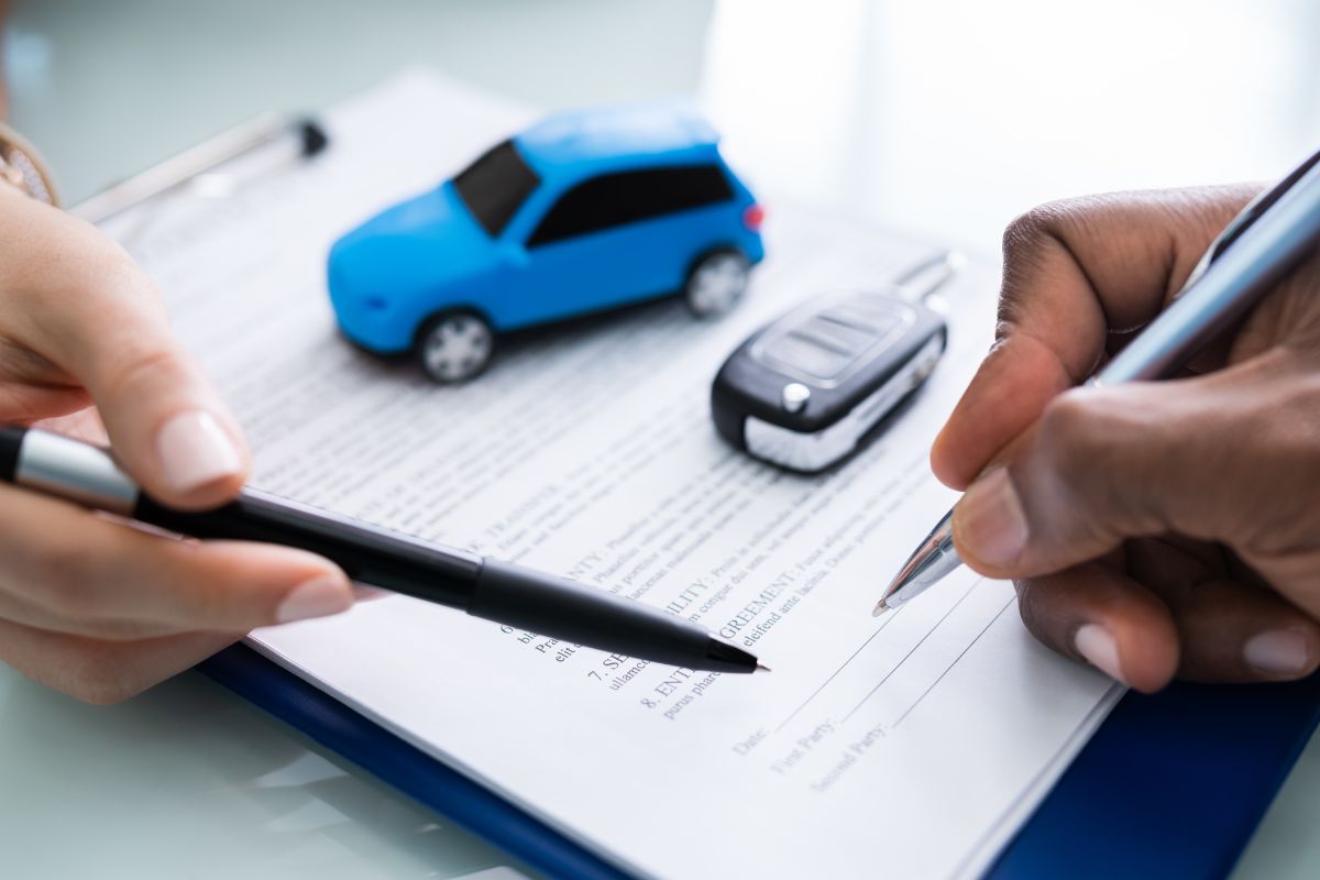 The photo shows a car loan signing contract.