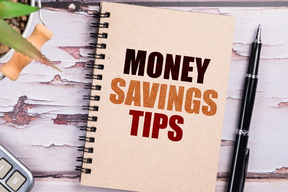 Picture of a notebook with money savings tips wording.