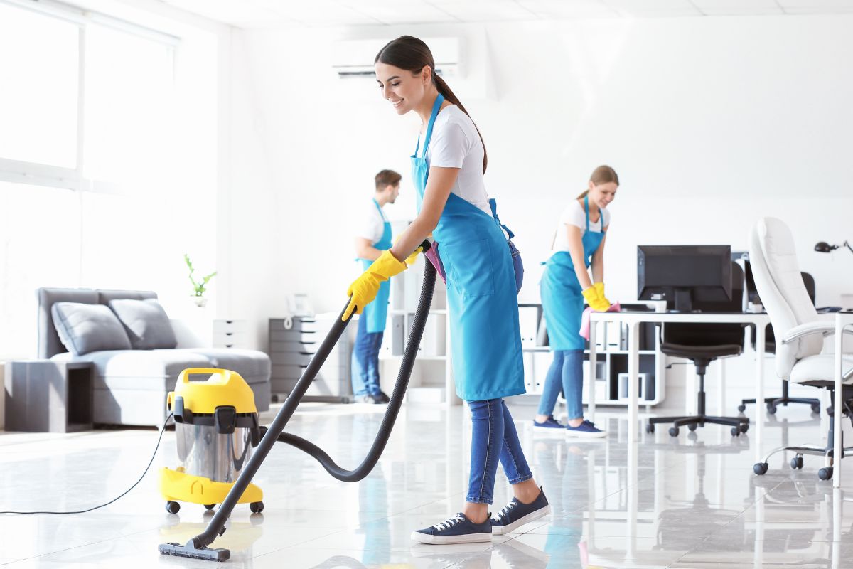 Picture of young workers cleaning the office.