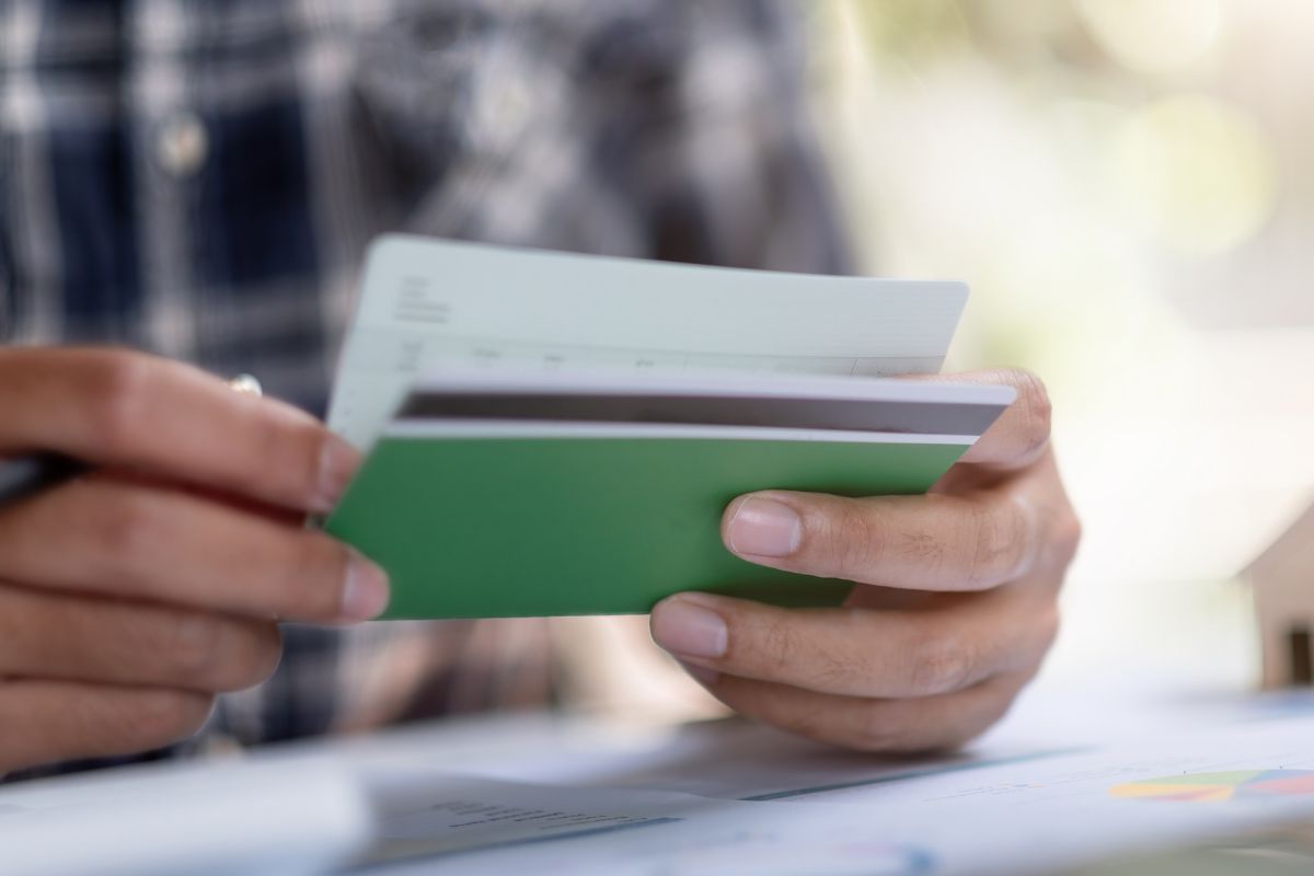 A man's hand checking his savings account.