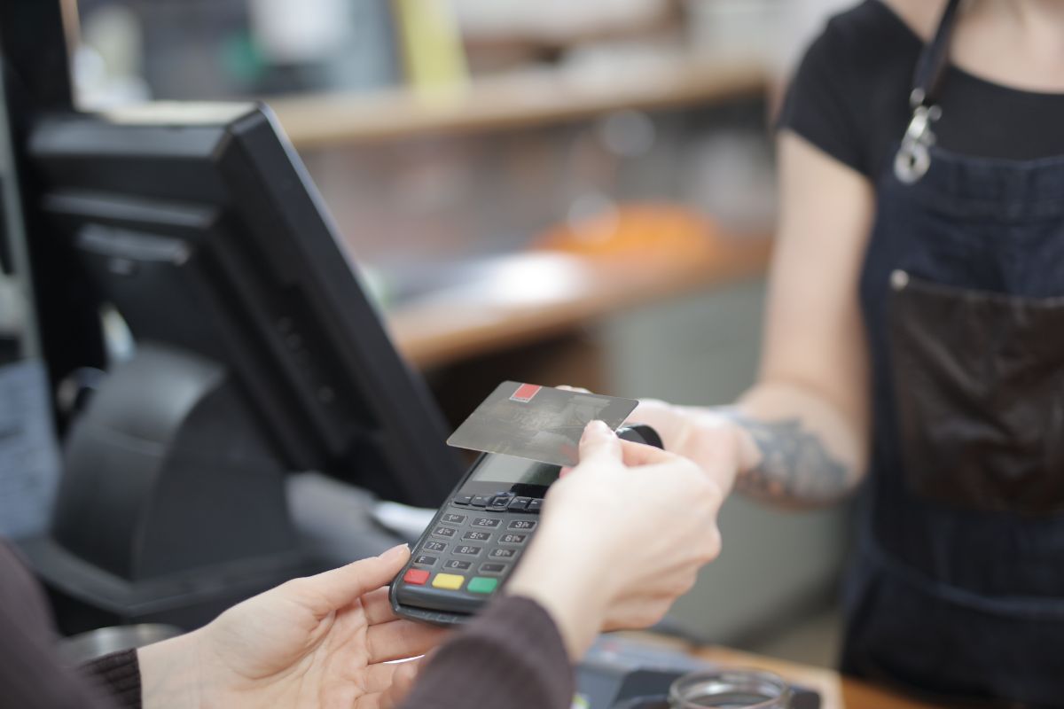Image of a woman paying with a credit card.
