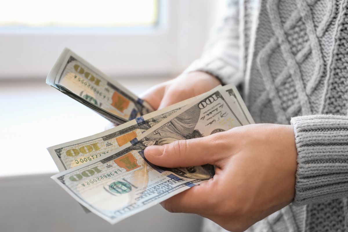A woman's hand counting money.
