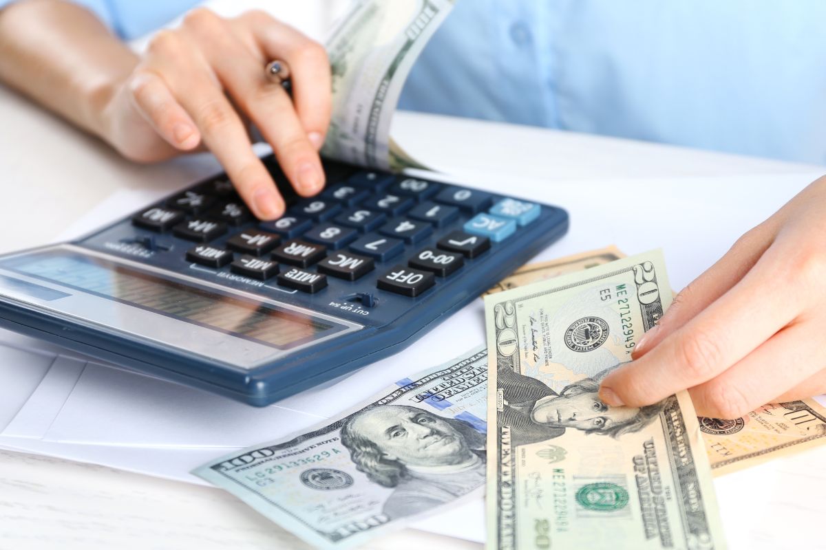 A woman's hand budgeting money.
