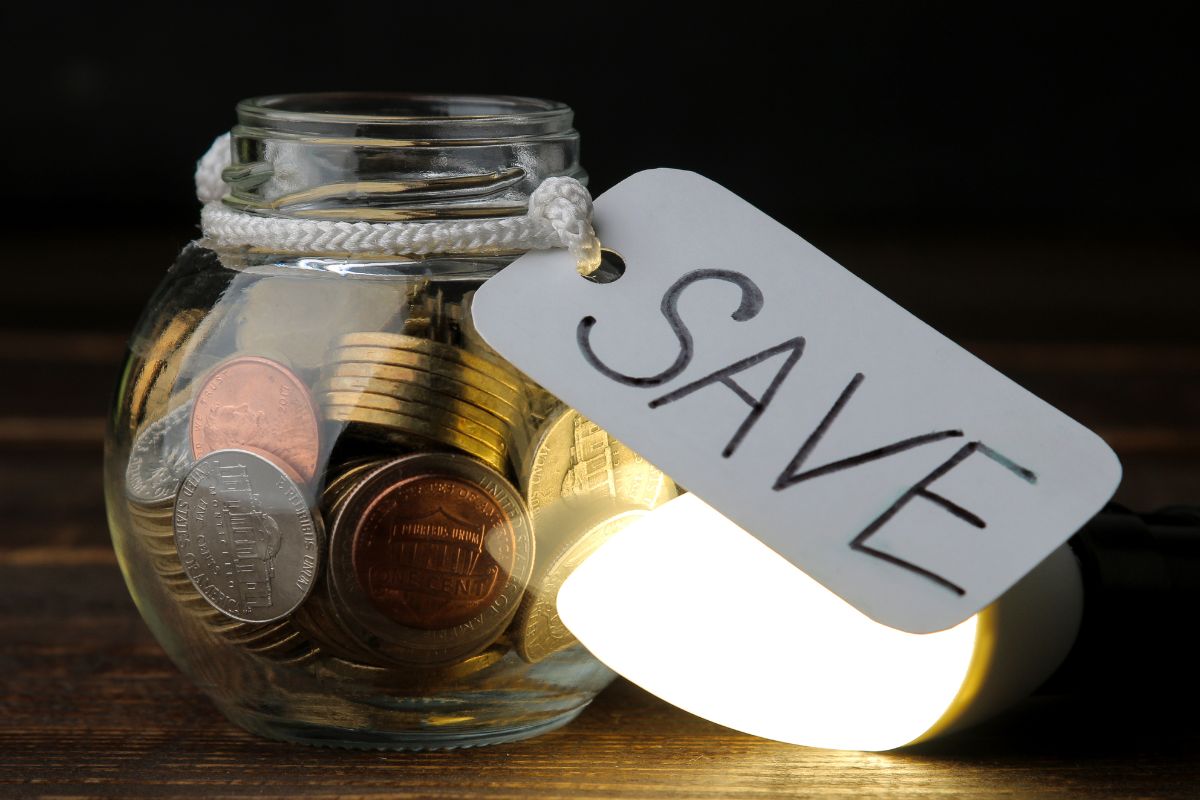 Photo of a jar with money and save tag.